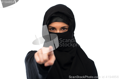 Image of muslim woman in hijab pointing finger to you