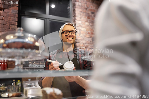 Image of man or barman with coffee cup and customer at cafe