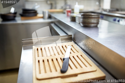 Image of cutting board and knife at restaurant kitchen