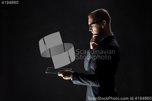 Image of close up of businessman with transparent tablet pc