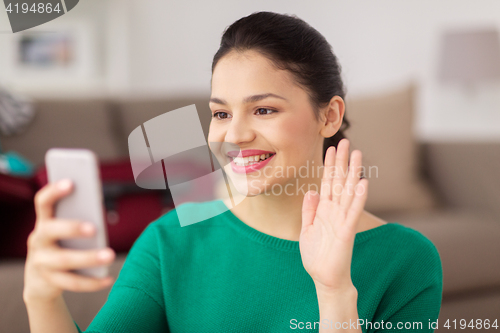 Image of woman with smartphone taking selfie or video call