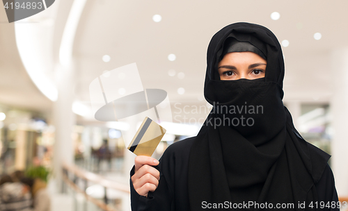 Image of muslim woman in hijab with credit card over white