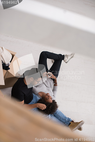 Image of African American couple relaxing in new house