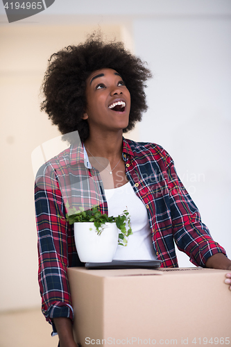 Image of Black girl moving in the new apartment