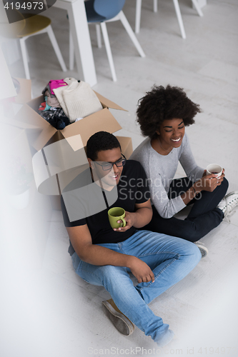 Image of African American couple relaxing in new house