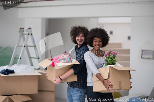 Image of multiethnic couple moving into a new home