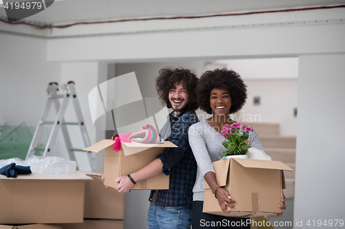 Image of multiethnic couple moving into a new home