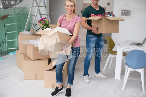 Image of young couple moving into a new home