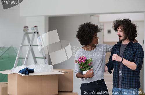 Image of multiethnic couple moving into a new home