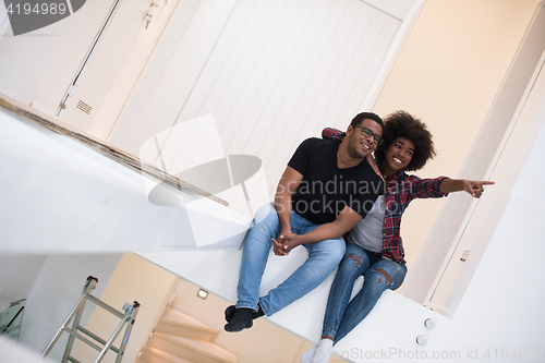 Image of couple having break during moving to new house