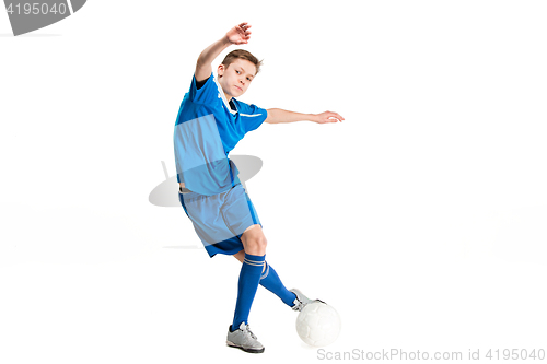 Image of Young boy with soccer ball doing flying kick