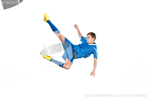 Image of Young boy with soccer ball doing flying kick