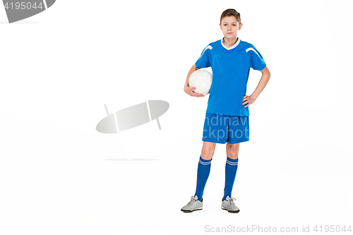 Image of Young boy with soccer ball doing flying kick