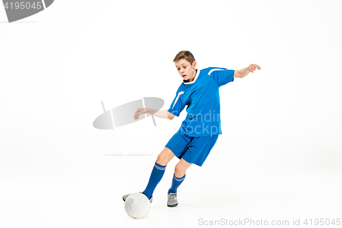 Image of Young boy with soccer ball doing flying kick