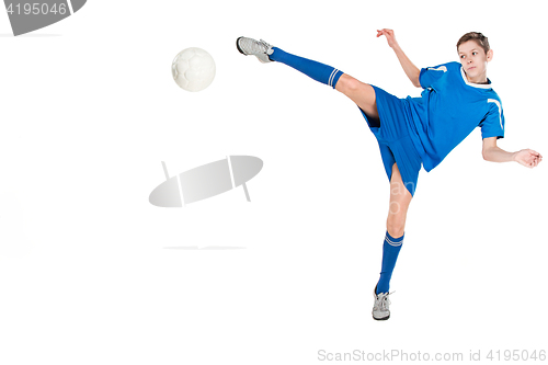 Image of Young boy with soccer ball doing flying kick