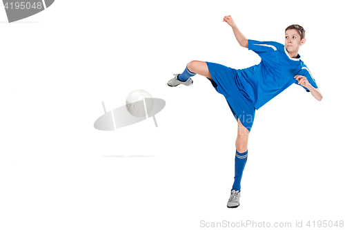 Image of Young boy with soccer ball doing flying kick