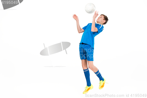 Image of Young boy with soccer ball doing flying kick