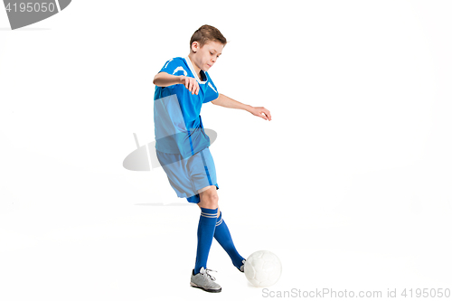 Image of Young boy with soccer ball doing flying kick