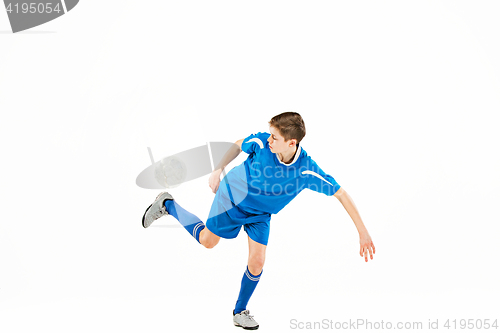 Image of Young boy with soccer ball doing flying kick