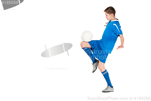 Image of Young boy with soccer ball doing flying kick