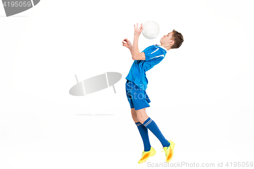 Image of Young boy with soccer ball doing flying kick