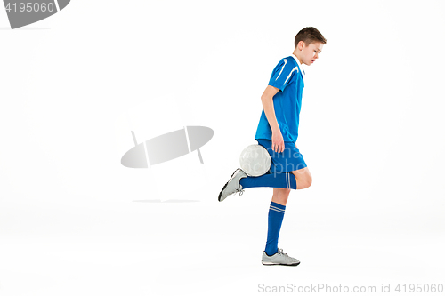 Image of Young boy with soccer ball doing flying kick
