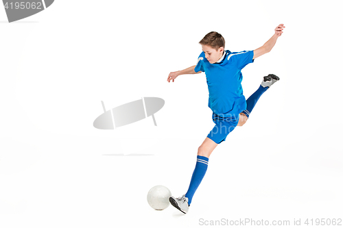 Image of Young boy with soccer ball doing flying kick