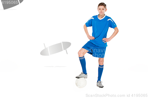 Image of Young boy with soccer ball doing flying kick