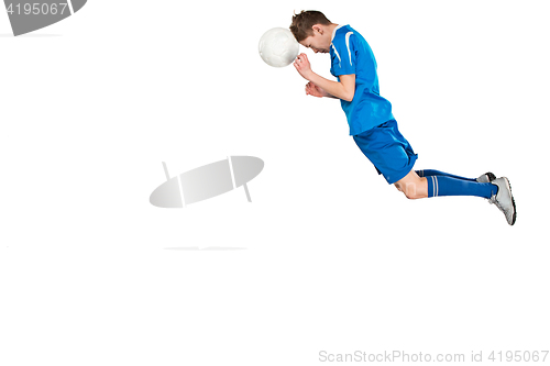 Image of Young boy with soccer ball doing flying kick