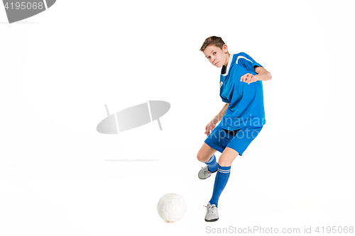 Image of Young boy with soccer ball doing flying kick