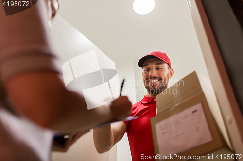 Image of deliveryman and customer with parcel boxes at home