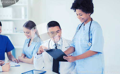 Image of group of happy doctors meeting at hospital office