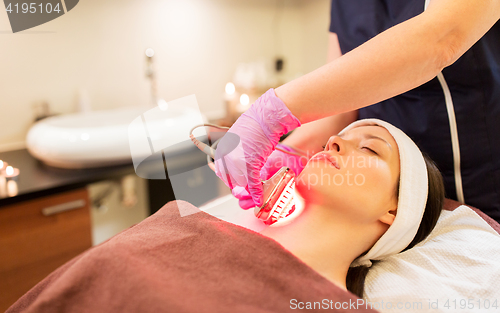 Image of young woman having face microdermabrasion at spa