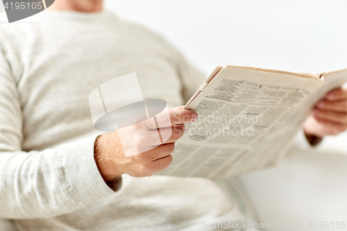 Image of close up of senior man reading newspaper