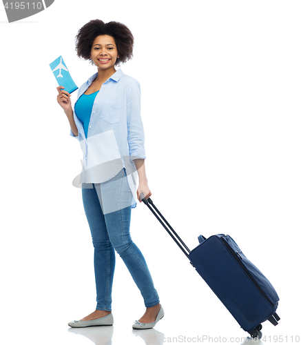 Image of happy woman with airplane ticket and travel bag