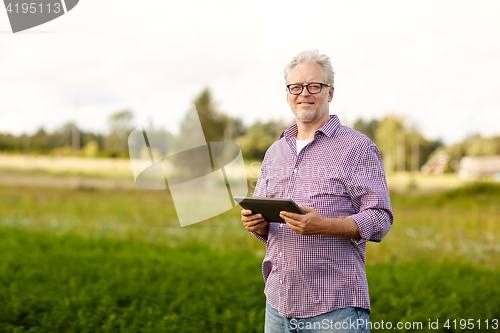 Image of senior man with tablet pc computer at county