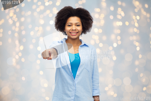 Image of happy african woman pointing finger to you