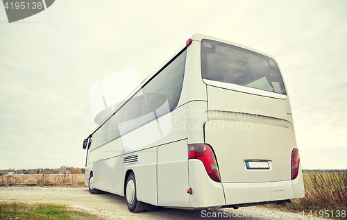 Image of tour bus driving outdoors