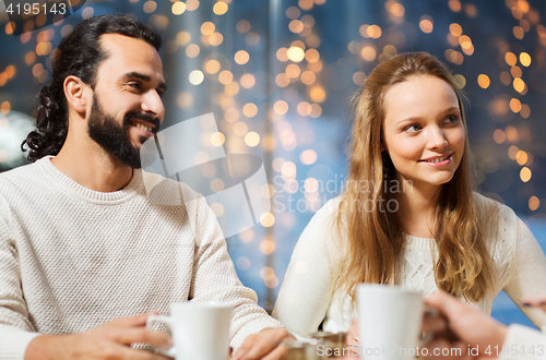 Image of happy couple meeting and drinking tea or coffee