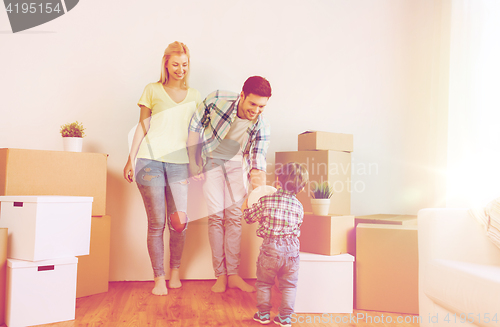 Image of happy family moving to new home and playing ball