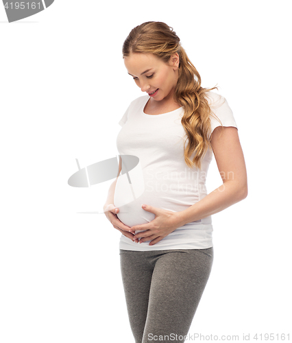 Image of happy pregnant woman touching her big belly