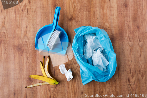 Image of rubbish bag with trash and cleaning items at home