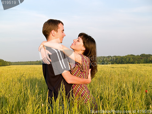 Image of Teen Couple Embrasing in Field