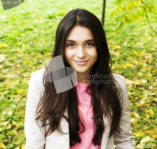 Image of Young cute smiling real stylish dressed woman in green palm park smiling, resting, enjoing, lifestyle outside concept