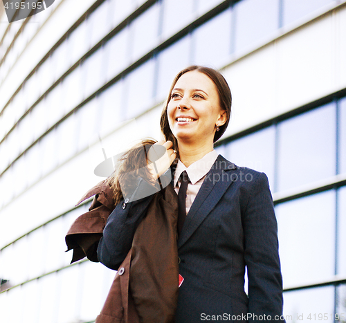 Image of young pretty girl near business building walking, student in ame