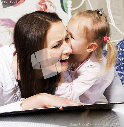 Image of mother with daughter together in bed smiling, happy family close up, lifestyle people concept, cool real modern family playing