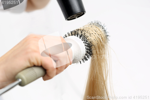 Image of Combing the hair drying brush