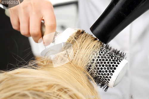 Image of Drying hair on a round brush