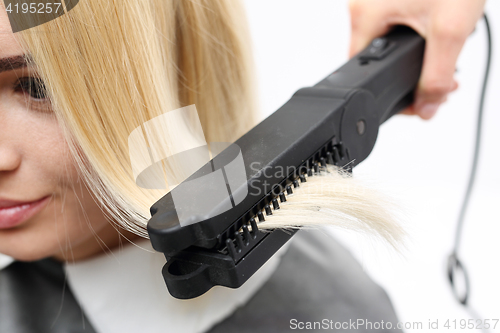 Image of Straightening. Iron barbershops, hair straightening. Keratin hair straightening.