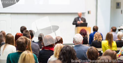 Image of Public speaker giving talk at Business Event.